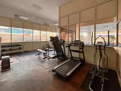 a gym with treadmills and machines in a room at Frank Porter - Marina Park in Dubai