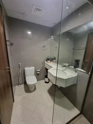 a bathroom with a toilet and a sink at The One by Anu in Dubai