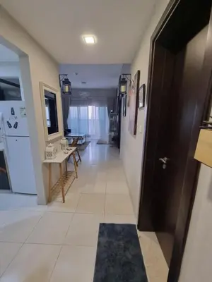 a hallway with a door and a table and chairs at The One by Anu in Dubai