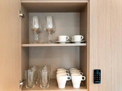 a cupboard with wine glasses and other items on it at The Chic Downtown Suite Luxury near Burj Khalifa in Dubai
