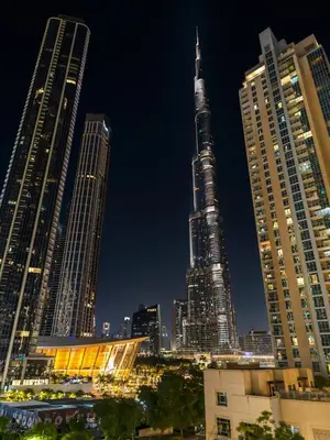 a city skyline at night with the tallest building at The Chic Downtown Suite Luxury near Burj Khalifa in Dubai