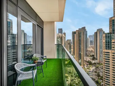 a balcony with a table and chairs and a view of the city at The Chic Downtown Suite Luxury near Burj Khalifa in Dubai