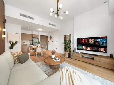 a living room with a couch and a tv at The Chic Downtown Suite Luxury near Burj Khalifa in Dubai