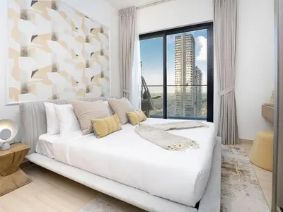 a white bed in a room with a large window at EasyGo- Peaceful 1BDR in Binghatti Heights JVC-01 in Dubai