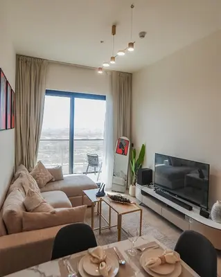 a living room with a couch and a tv at EasyGo- Peaceful 1BDR in Binghatti Heights JVC-01 in Dubai
