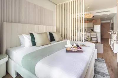 a bedroom with a large white bed with a tray on it at Frank Porter - Rokane G25 in Dubai