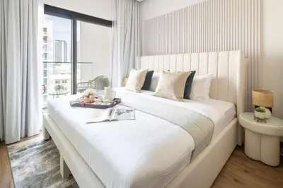 a bedroom with a large white bed with a window at Frank Porter - Rokane G25 in Dubai