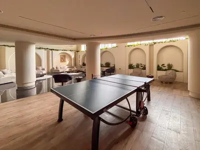 a ping pong table in the middle of a living room at Frank Porter - Rokane G25 in Dubai