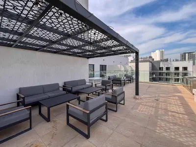 a patio with benches and tables on a building at Frank Porter - Rokane G25 in Dubai