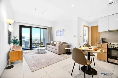 a kitchen and living room with a couch and a table at Sleek 1BR w Canal Views Next to Dubai Mall in Dubai