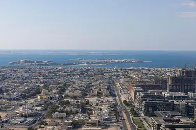 an aerial view of a city and the ocean at LUXE - 2BR - Sea & City View - 5 Min to Dubai Mall in Dubai