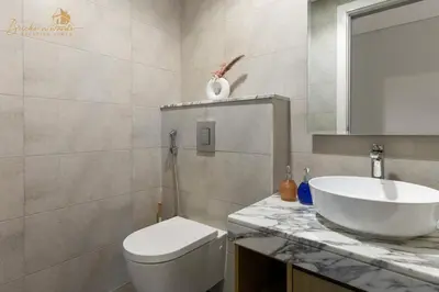 a bathroom with a white toilet and a sink at Glorious Sea View 3Bhk 6pax in Dubai