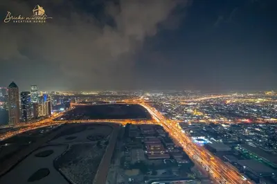 an aerial view of a city at night at Sea & Sunset View 2Bhk 5pax in Dubai