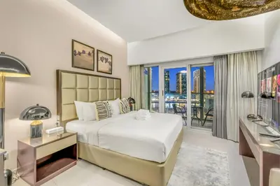 a bedroom with a large bed and a balcony at LUX Apt 5 min away from Burj Khalifa & Dubai Mall in Dubai