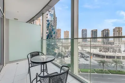 a balcony with a table and chairs and a view of a city at LUX Apt 5 min away from Burj Khalifa & Dubai Mall in Dubai