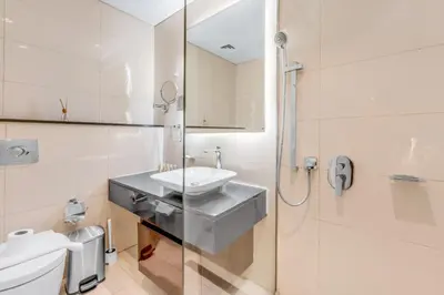 a bathroom with a sink and a toilet and a shower at LUX Apt 5 min away from Burj Khalifa & Dubai Mall in Dubai