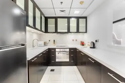 a kitchen with a stainless steel refrigerator and white counters at Stunning 1 BR in JBR Dubai Marina The Walk in Dubai