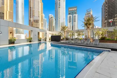 a swimming pool in the middle of a city with tall buildings at Stunning 1 BR in JBR Dubai Marina The Walk in Dubai