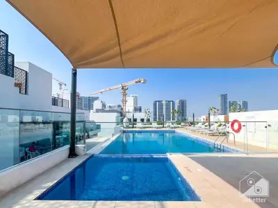 a large swimming pool on top of a building at Rokane G25 Studio Modern Comfort with City Views in Dubai