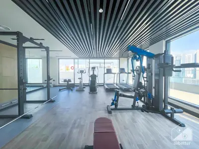 a gym with treadmills and machines in a building at Rokane G25 Studio Modern Comfort with City Views in Dubai