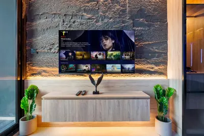 a table in a room with a tv on a wall at Exclusive Apt 4 Pex with Burj Khalifa View in Dubai