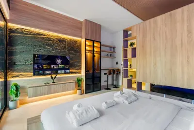 a bedroom with a large white bed and a flat screen tv at Exclusive Apt 4 Pex with Burj Khalifa View in Dubai