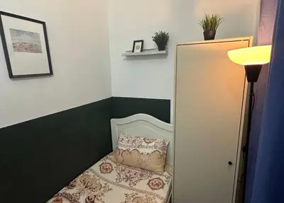 a small bedroom with a bed with a pillow at Gateway Partition Room in Barsha Mashreq Metro in Dubai