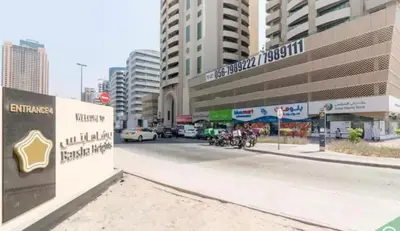 a street in a city with buildings and cars at Cityscape Room In Tecom Near ICM Metro in Dubai