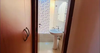 a bathroom with a sink and a shower curtain at Cityscape Room In Tecom Near ICM Metro in Dubai