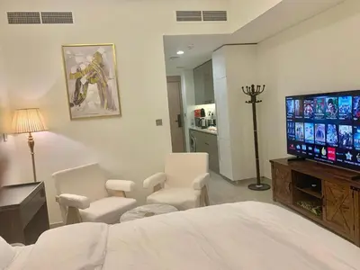 a bedroom with a bed and a flat screen tv at Azizi Rivera Luxury Studio in Dubai