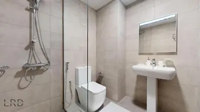a bathroom with a shower and a toilet and a sink at Modern Furnished Studio in Dubai