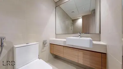 a bathroom with a sink and a toilet and a mirror at Stylish Studio Retreat in Azizi Farhad in Dubai