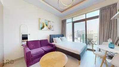a hotel room with a bed and a purple chair at Stylish Studio Retreat in Azizi Farhad in Dubai