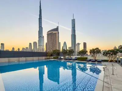 a swimming pool with a view of the dubai city at Elegant 4BR Apartment with Burj Khalifa and Fountain Views Connected to Dubai Mall in Dubai