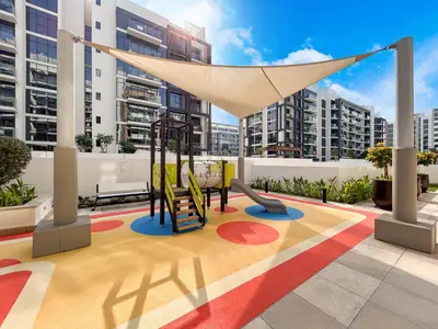 a playground on the roof of a building with tall buildings at Chic & Beautiful Home in the Heart of Meydan in Dubai