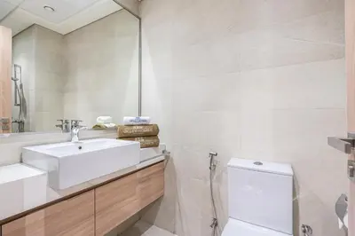 a bathroom with a sink and a toilet at Chic & Beautiful Home in the Heart of Meydan in Dubai