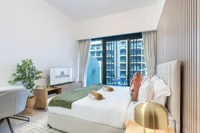 a bedroom with a bed and a large window at Chic & Beautiful Home in the Heart of Meydan in Dubai