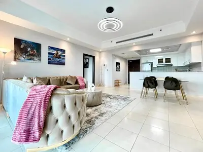 a living room with a couch and a kitchen at Homes 2 Retreat - Luxury & Spacious 1BR with Balcony in Business Bay in Dubai