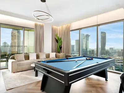 a living room with a pool table at Royal Vista - Luxury 4BR Apartment at Downtown Views II - Downtown in Dubai