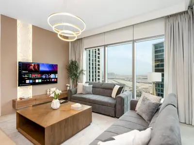 a living room with a couch and a table at Royal Vista - Luxury 4BR Apartment at Downtown Views II - Downtown in Dubai
