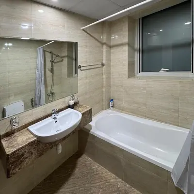 a bathroom with a white tub and a sink at Preatoni Tower - JLT by Golden Casa in Dubai
