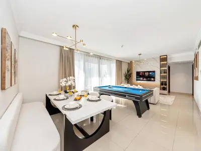 a living room with a pool table and a couch at Royal Vista - Luxury 4BR Apartment at Boulevard Point - Downtown in Dubai