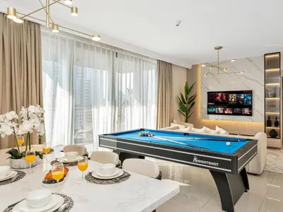 a living room with a pool table at Royal Vista - Luxury 4BR Apartment at Boulevard Point - Downtown in Dubai