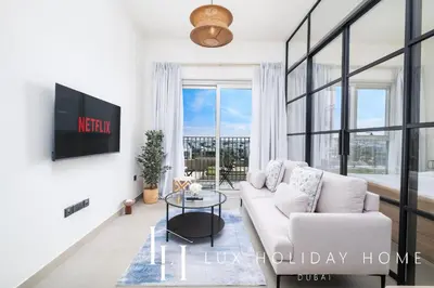 a living room with a couch and a table at LUX The Collective Dubai Hills Suite in Dubai