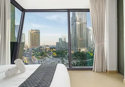 a bedroom with a large window with a view of a city at Royal Vista - Luxury 2BR Apartment with Burj Khalifa View at Burj Vista - Downtown in Dubai