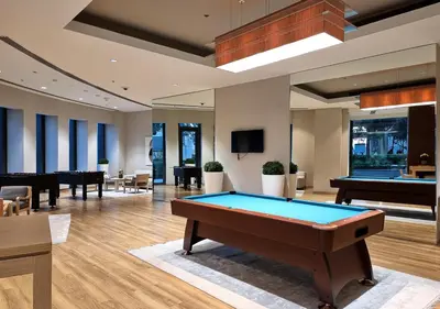 a billiard room with a pool table and tables at Royal Vista - Luxury 2BR Apartment with Burj Khalifa View at Burj Vista - Downtown in Dubai