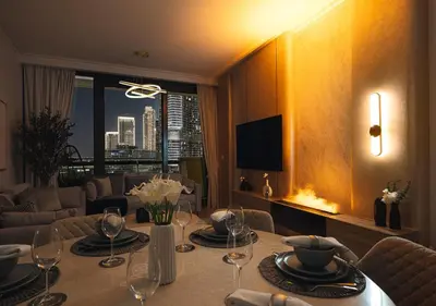 a dining room with a table with wine glasses on it at Royal Vista - Luxury 2BR Apartment with Burj Khalifa View at Burj Vista - Downtown in Dubai