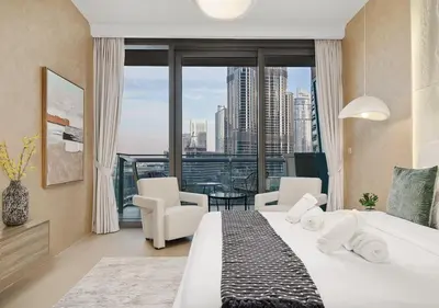 a bedroom with a bed and a view of a city at Royal Vista - Luxury 2BR Apartment with Burj Khalifa View at Burj Vista - Downtown in Dubai