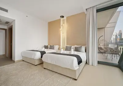 a hotel room with two beds and a balcony at Royal Vista - Luxury 2BR Apartment with Burj Khalifa View at Burj Vista - Downtown in Dubai