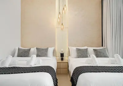 two beds sitting next to each other in a room at Royal Vista - Luxury 2BR Apartment with Burj Khalifa View at Burj Vista - Downtown in Dubai